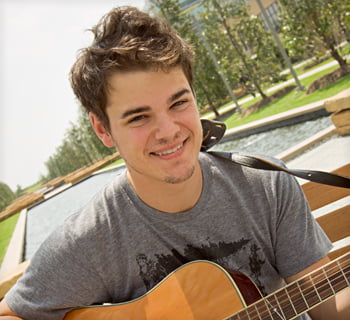 UT Dallas student with guitar