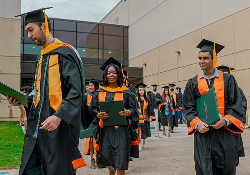 UT Dallas graduates in academic dress